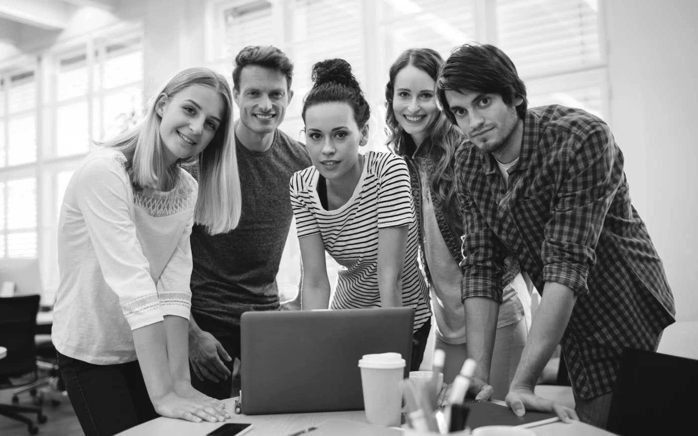 The Interlaunch team gathered around a laptop